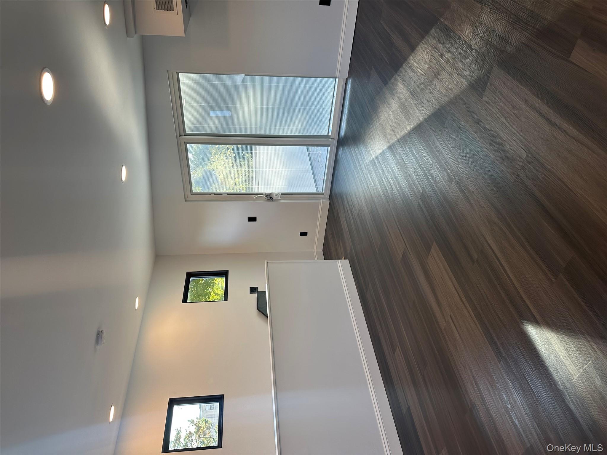 5918 Delafield Avenue Bronx, NY 10471 - Photo 25 of 31 an empty room with wooden floor and windows