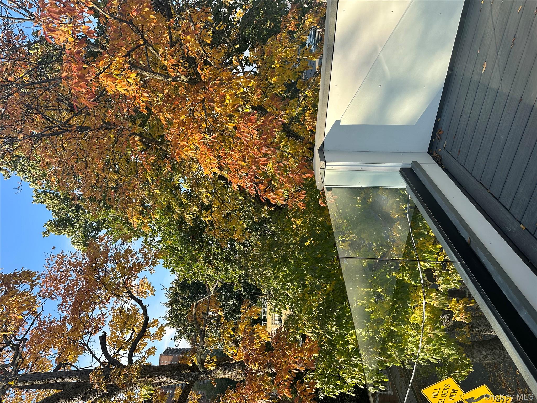 5918 Delafield Avenue Bronx, NY 10471 - Photo 27 of 31 a view of a wooden floor and a yard from a balcony