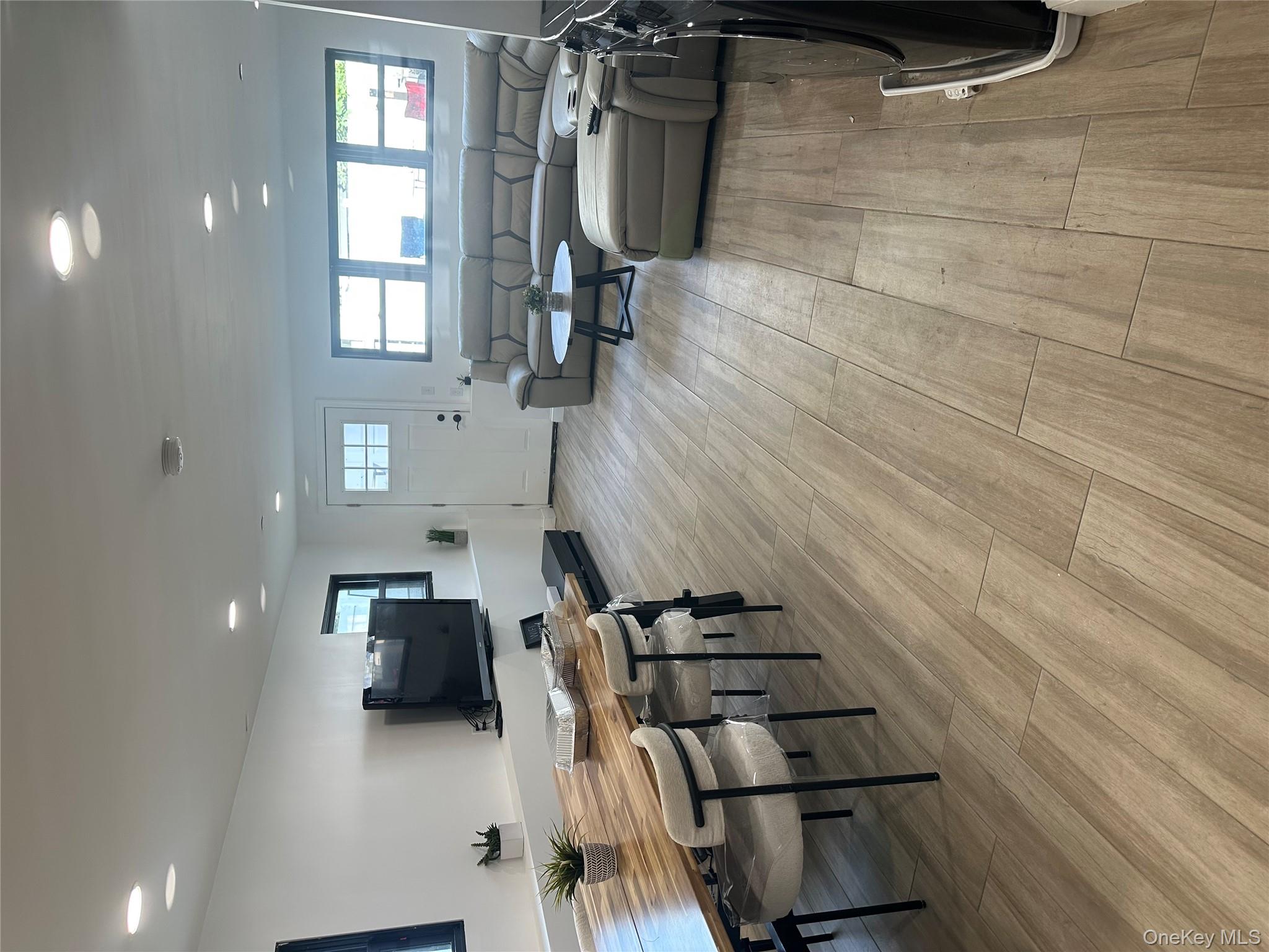 5918 Delafield Avenue Bronx, NY 10471 - Photo 30 of 31 a living room with furniture and a flat screen tv