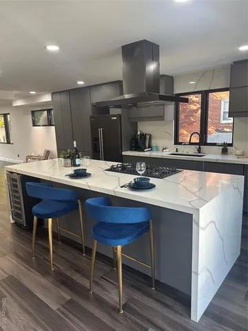 a kitchen with a sink and a mirror