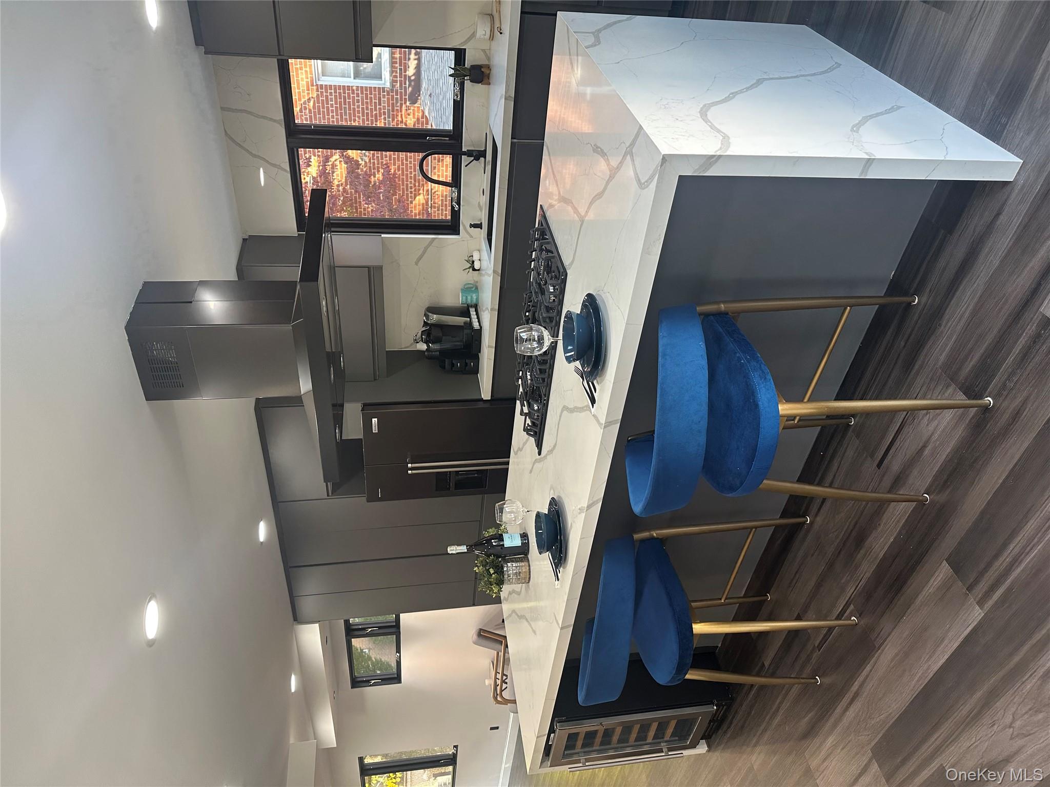 5918 Delafield Avenue Bronx, NY 10471 - Photo 8 of 31 a kitchen with a sink cabinets and dining table