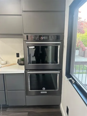 a kitchen with a sink cabinets and wooden floor