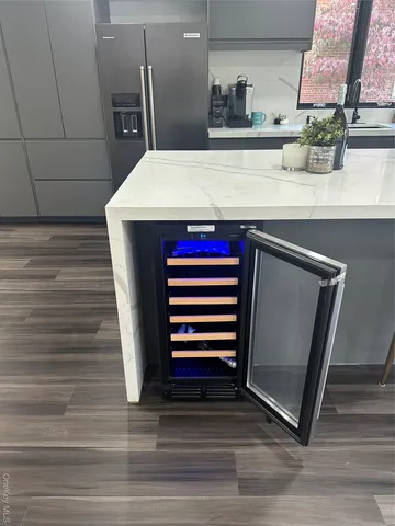 a kitchen with stainless steel appliances granite countertop a refrigerator and a sink