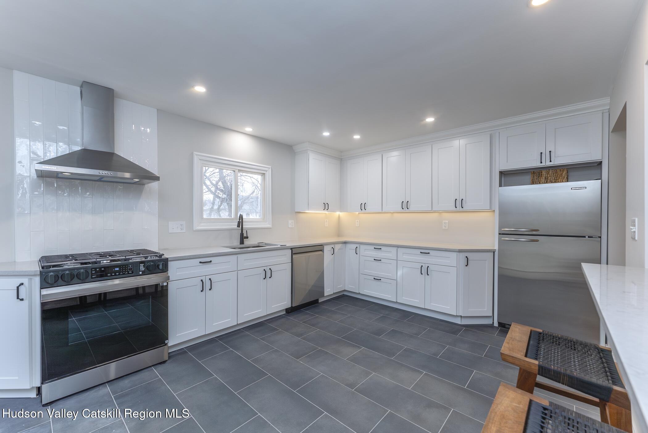 64 1st Avenue Kingston, NY 12401 - Photo 15 of 37 a kitchen with a stove sink and refrigerator