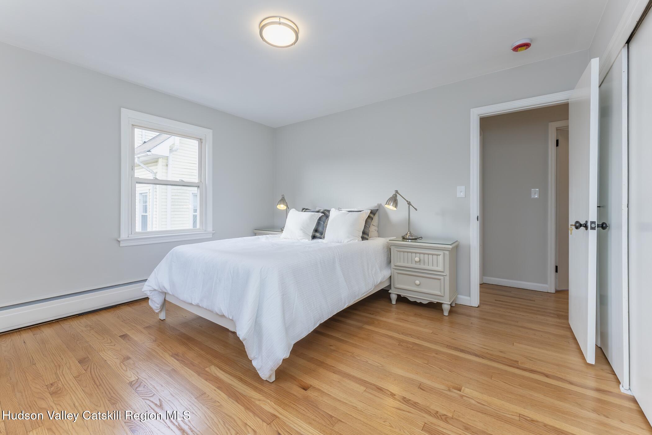 64 1st Avenue Kingston, NY 12401 - Photo 20 of 37 a bedroom with a bed and a window