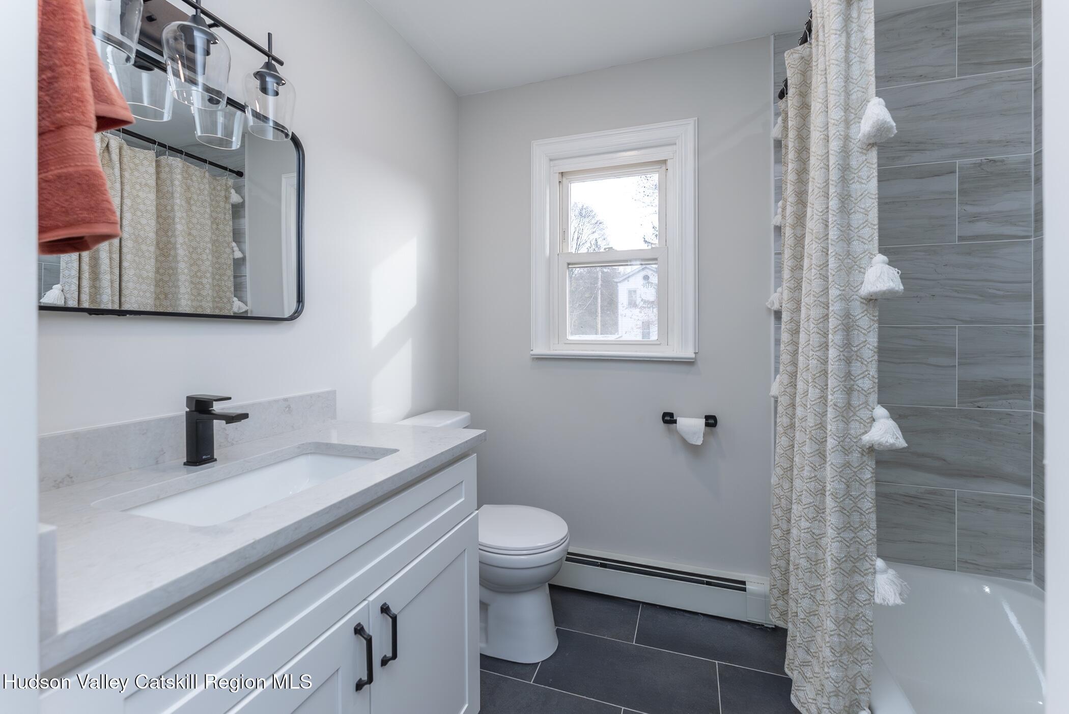64 1st Avenue Kingston, NY 12401 - Photo 22 of 37 a bathroom with a sink a toilet and shower