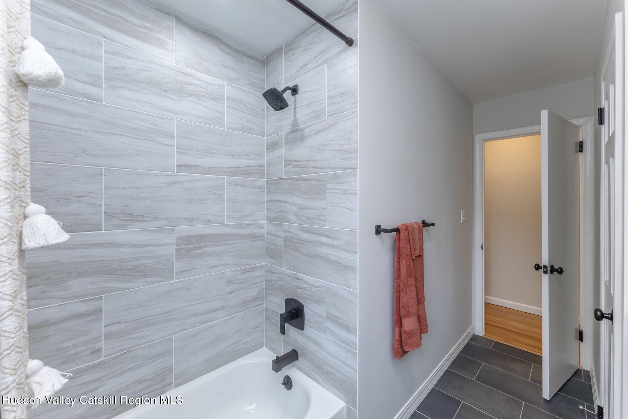 64 1st Avenue Kingston, NY 12401 - Photo 23 of 37 a bathroom with a bathtub and shower