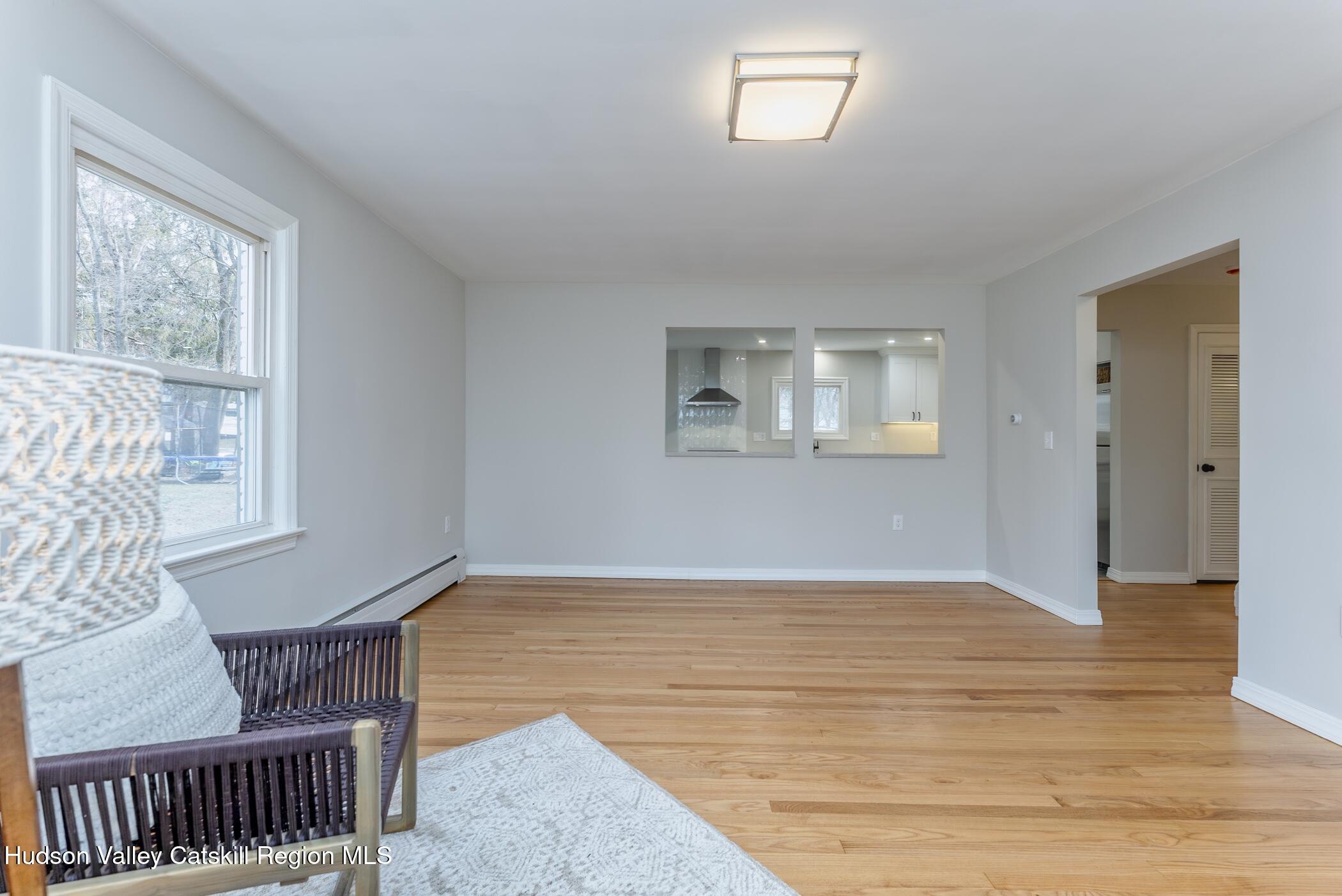64 1st Avenue Kingston, NY 12401 - Photo 5 of 37 a view of an empty room with wooden floor and a window