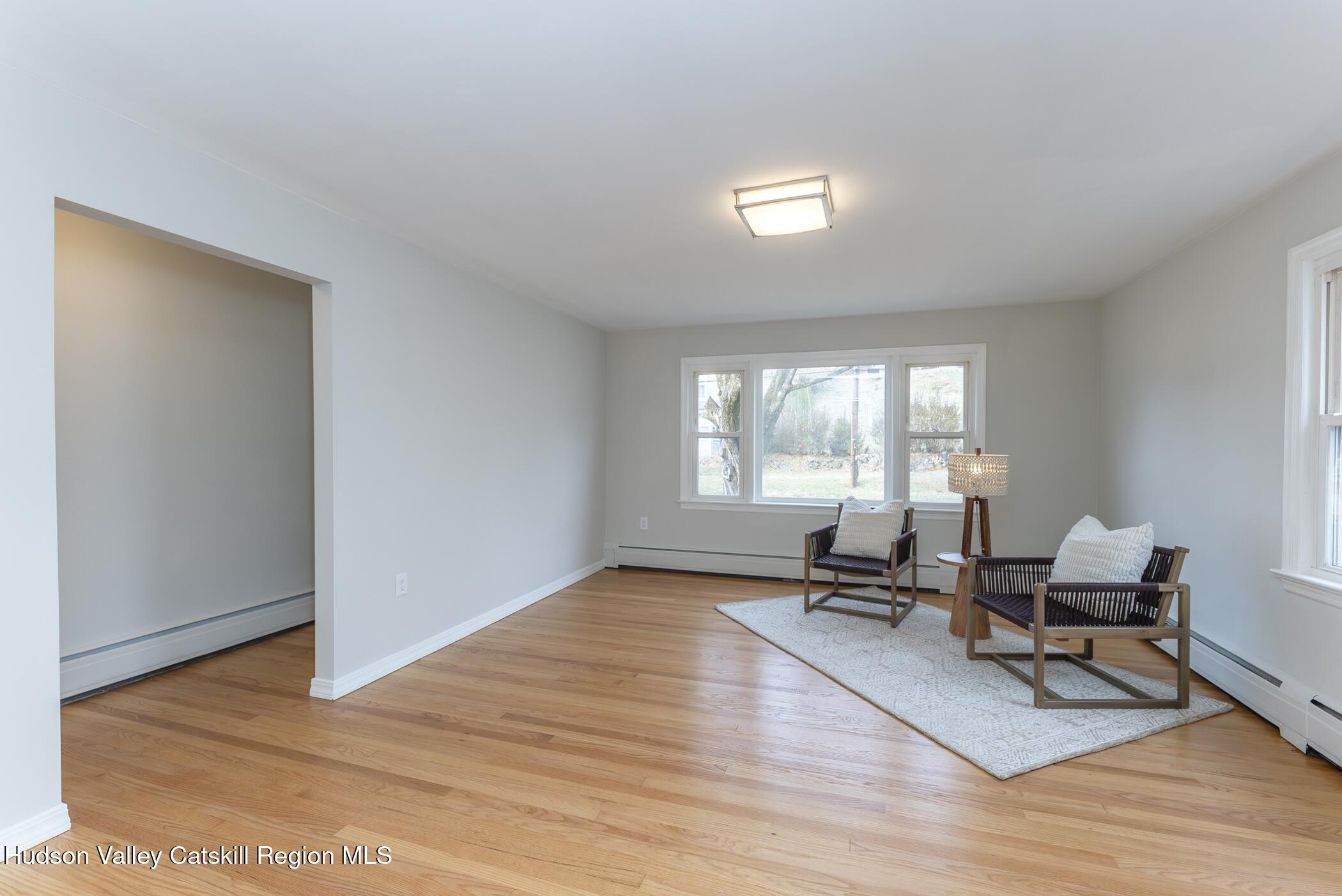 64 1st Avenue Kingston, NY 12401 - Photo 9 of 37 a living room with furniture window and a wooden floor