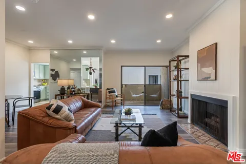 a living room with furniture a fireplace and a table
