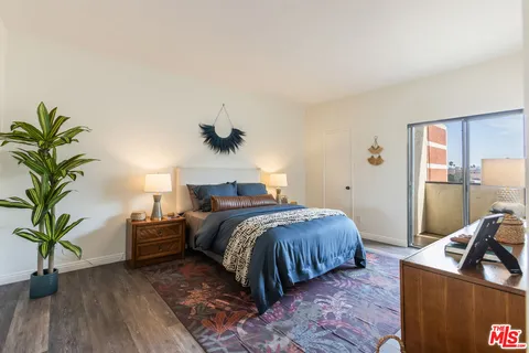 a bed room with a bed and a potted plant