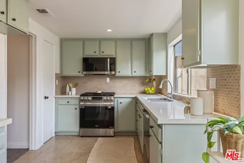 a kitchen with a stove a sink and a microwave