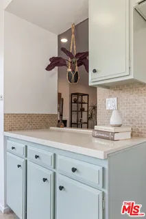 a kitchen with a sink cabinets and appliances