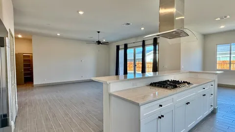 a stove top oven sitting inside of a kitchen