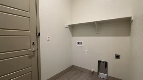 a view of storage and utility room with racks on the wall