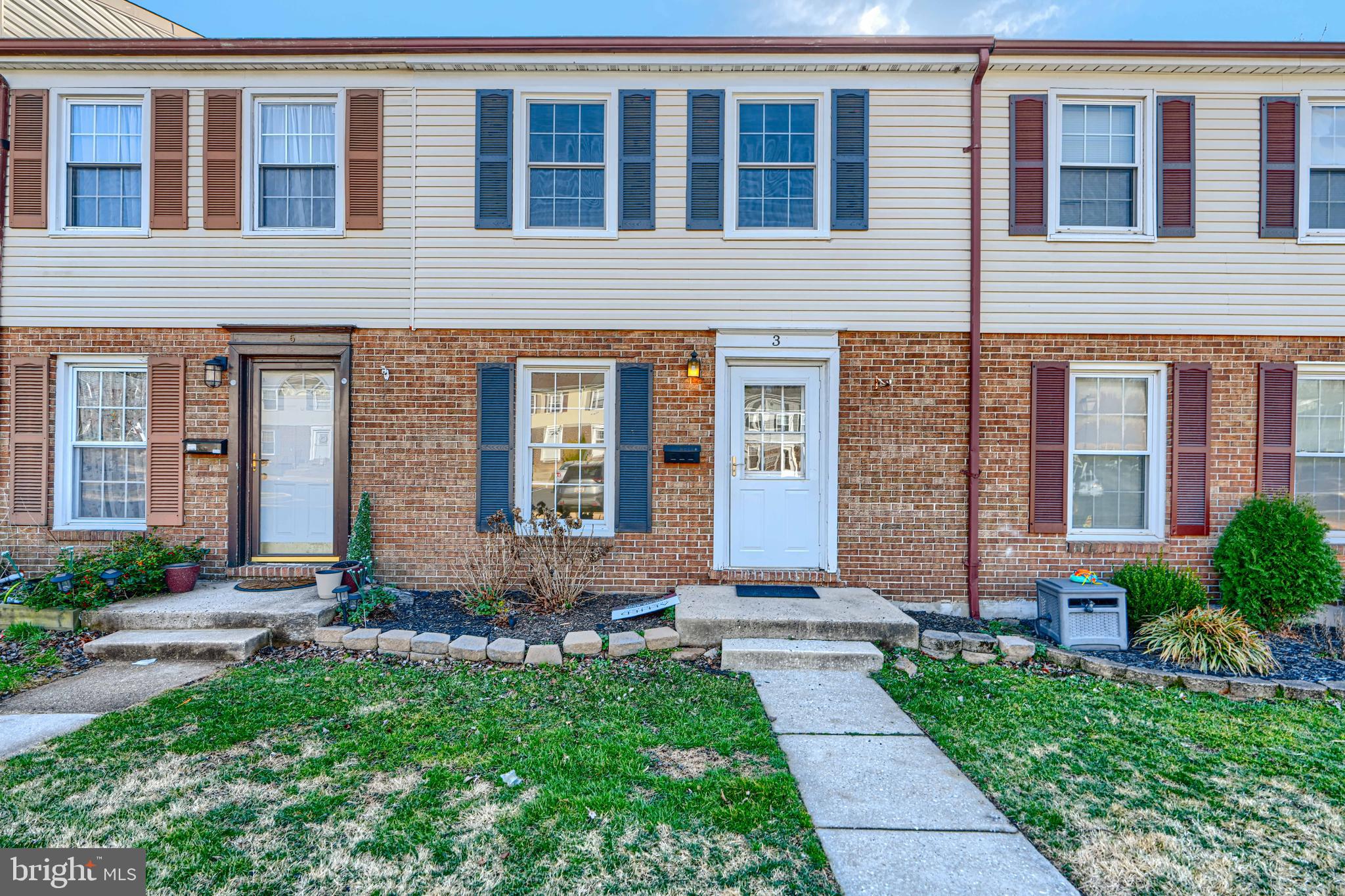 a front view of a house with yard and outdoor seating