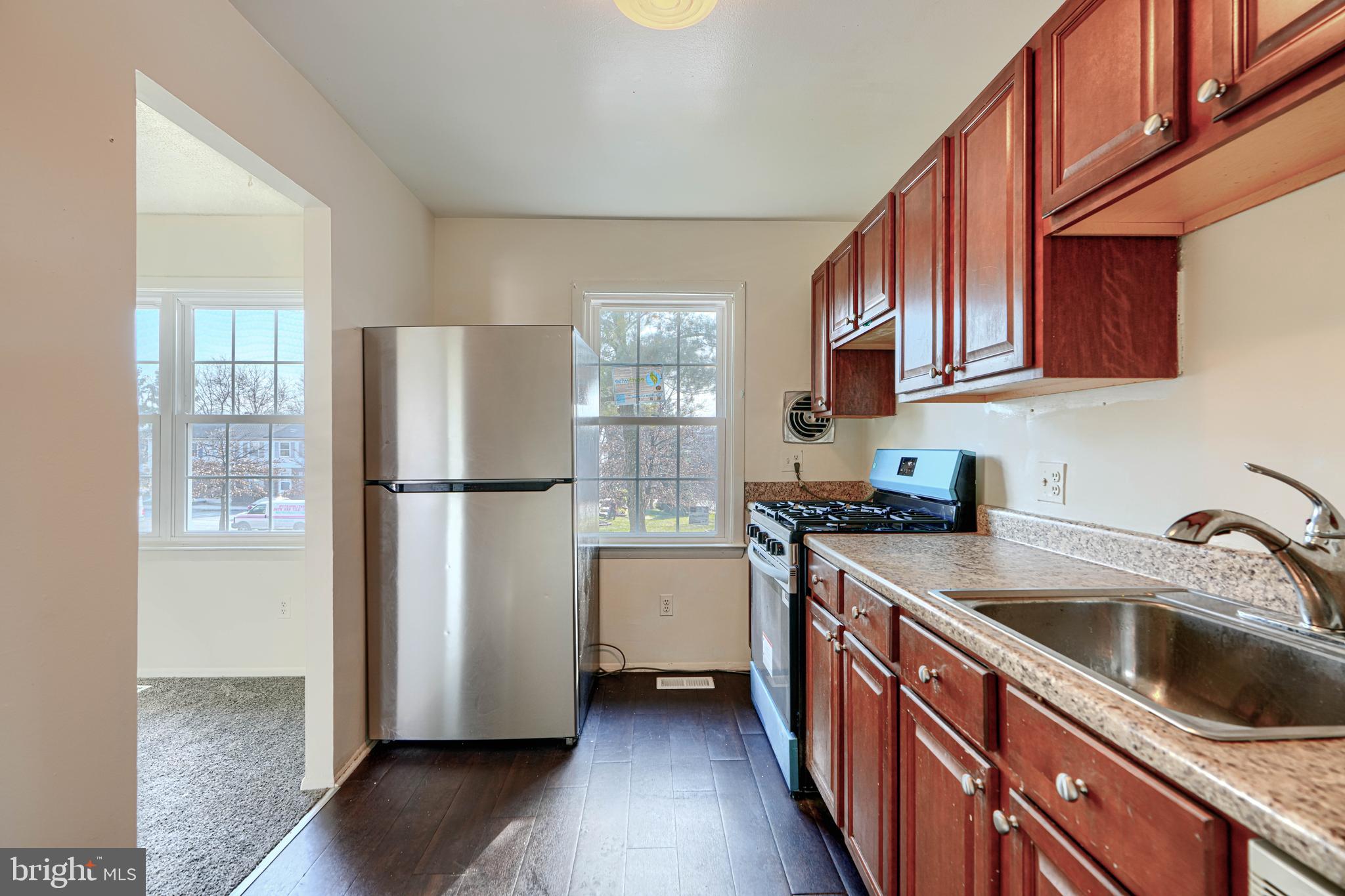 3 Slavin Court, Unit 2K Nottingham, MD 21236 - Photo 11 of 39 a kitchen with a refrigerator sink and cabinets