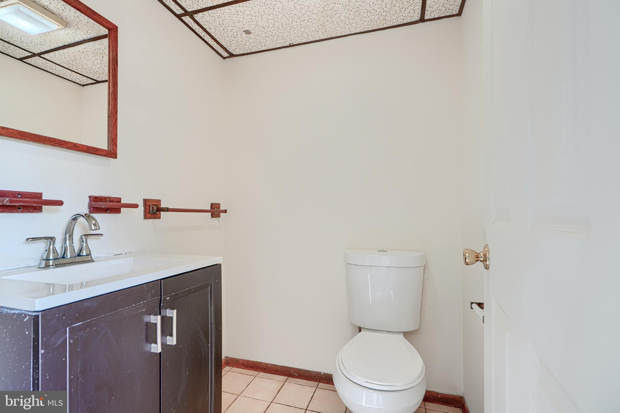 3 Slavin Court, Unit 2K Nottingham, MD 21236 - Photo 33 of 39 a bathroom with a sink a toilet and a mirror