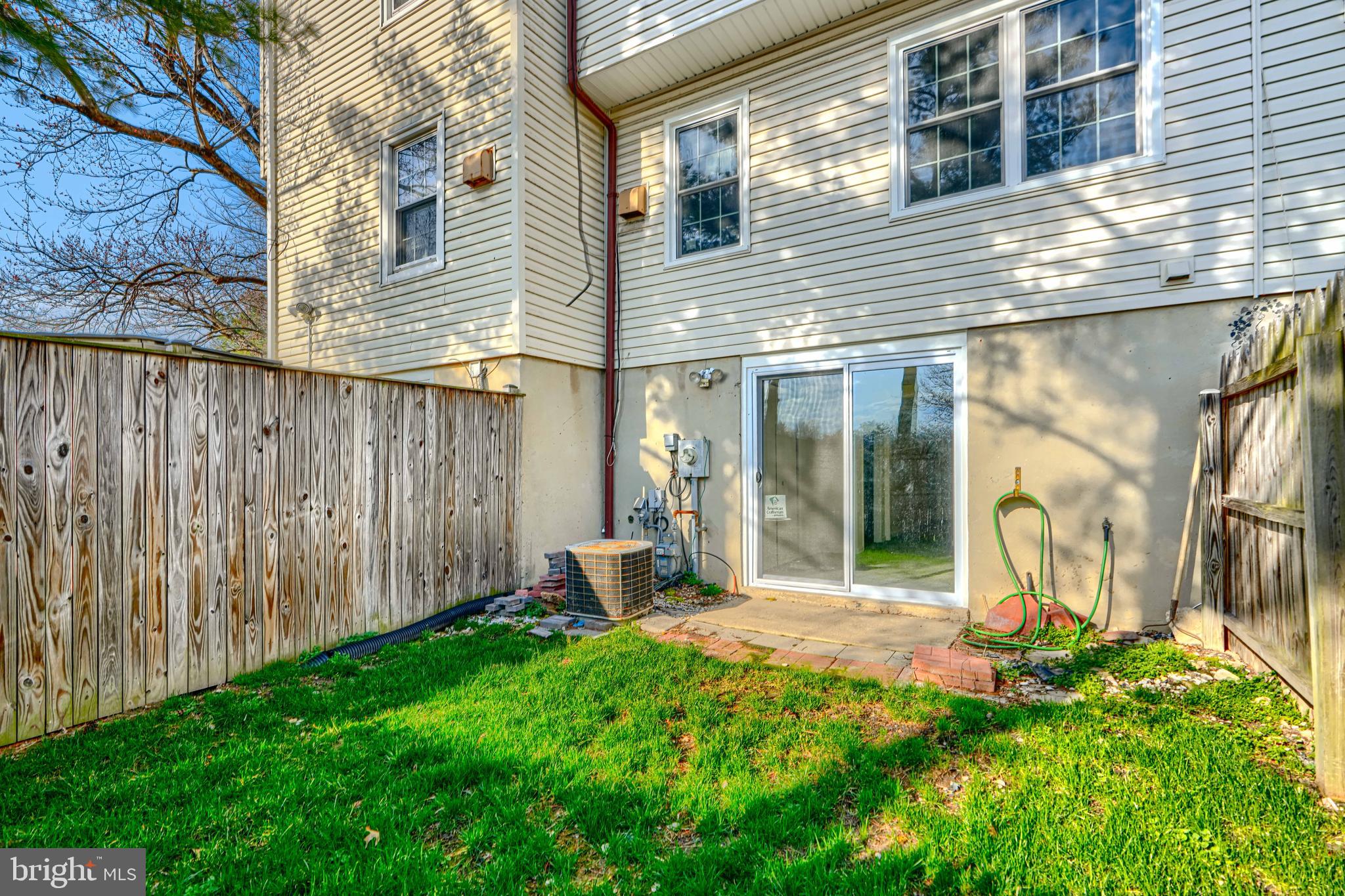 3 Slavin Court, Unit 2K Nottingham, MD 21236 - Photo 38 of 39 a view of a backyard with table and chairs and wooden fence
