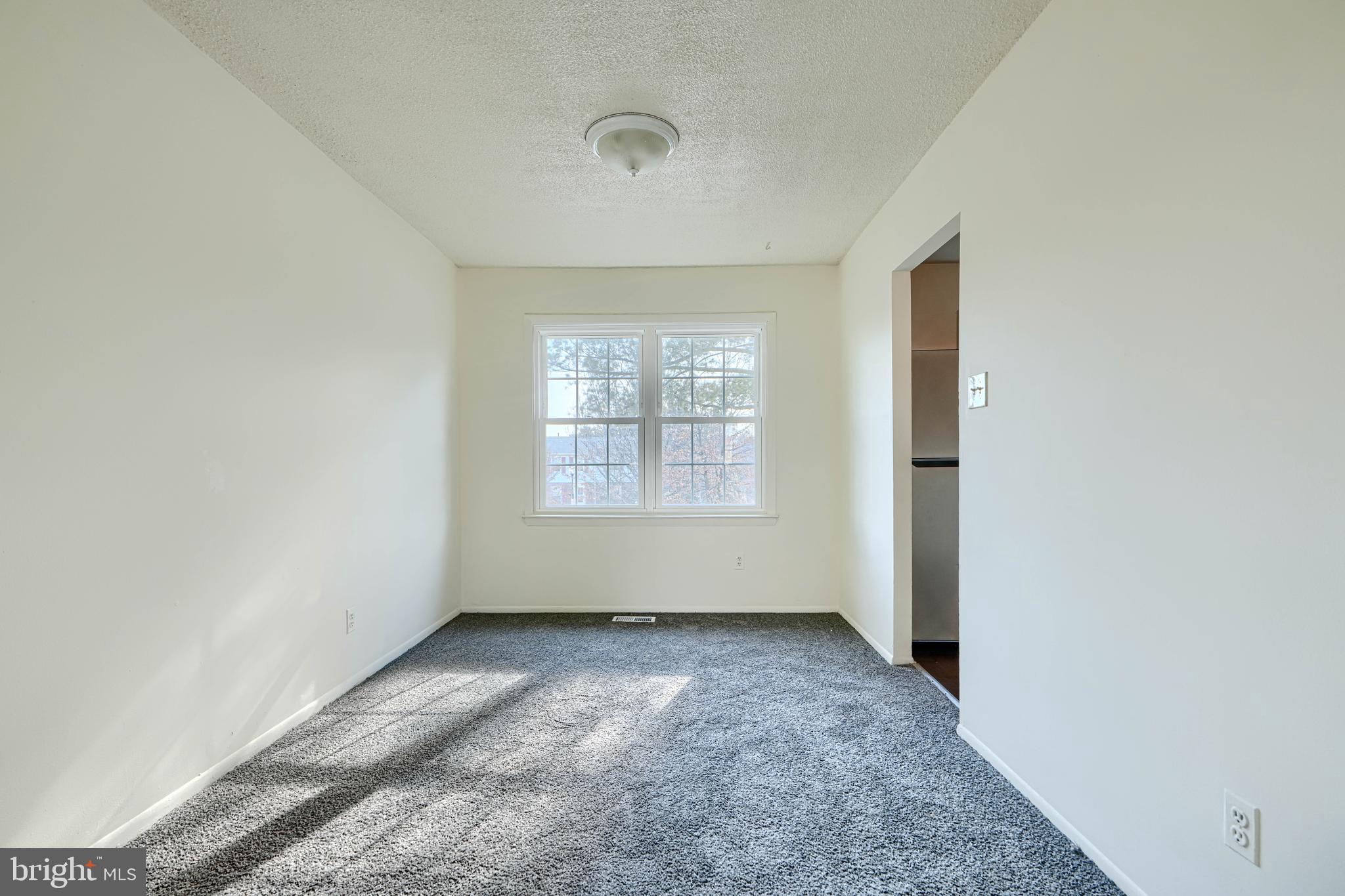 3 Slavin Court, Unit 2K Nottingham, MD 21236 - Photo 6 of 39 an empty room with wooden floor and windows
