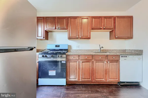 a kitchen with granite countertop cabinets and steel stainless steel appliances