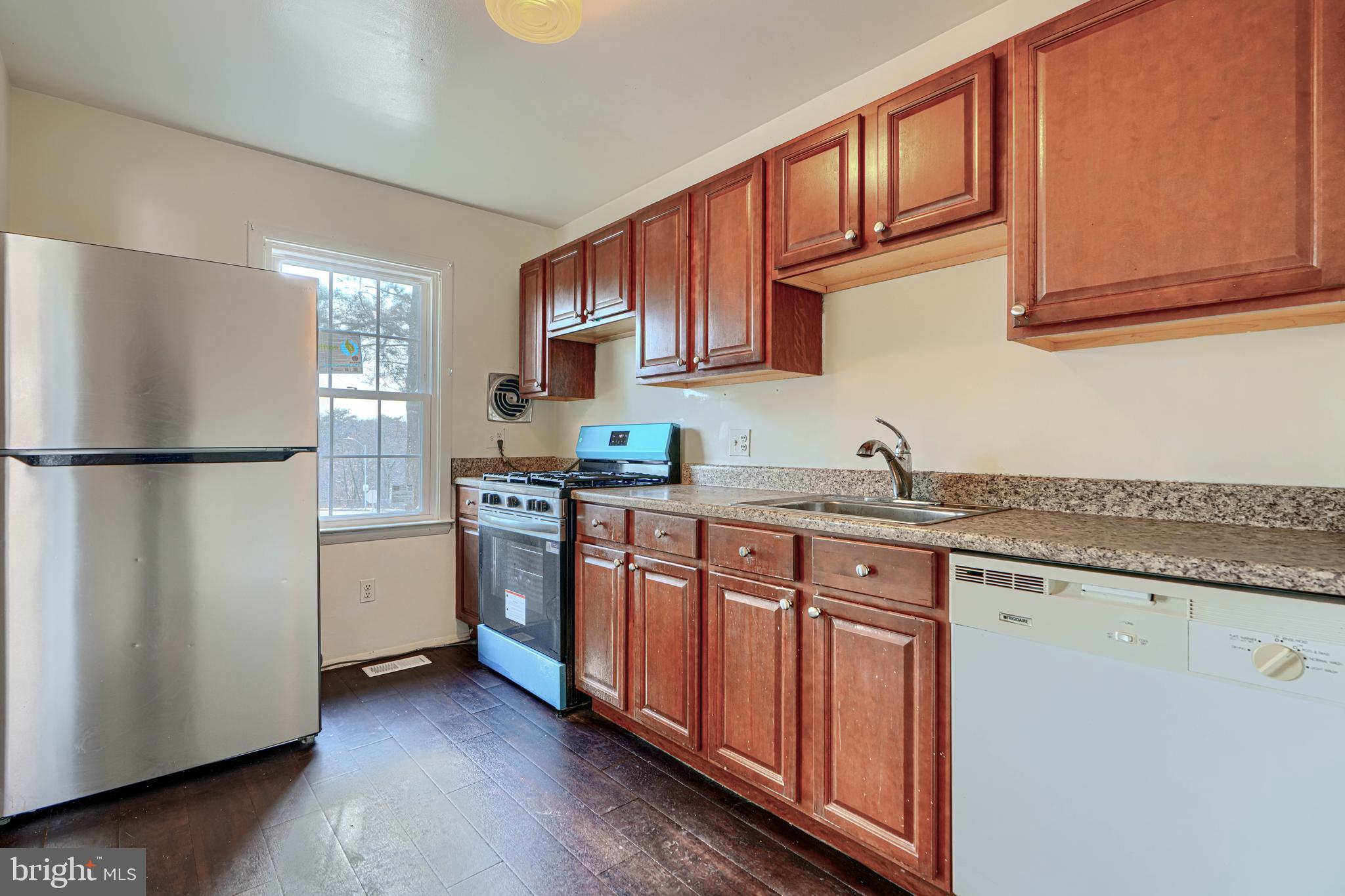 3 Slavin Court, Unit 2K Nottingham, MD 21236 - Photo 10 of 39 a kitchen with stainless steel appliances granite countertop a refrigerator sink and cabinets