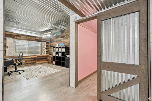 7296 Ridge Road Lake Point, UT 84074 - Photo 35 of 54 Corrugated metal ceiling and accent wall with wood-finish flooring