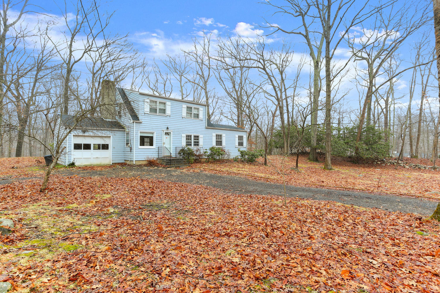 161 Spring Water Lane New Canaan, CT 06840 - Photo 1 of 9 a house with trees in front of it