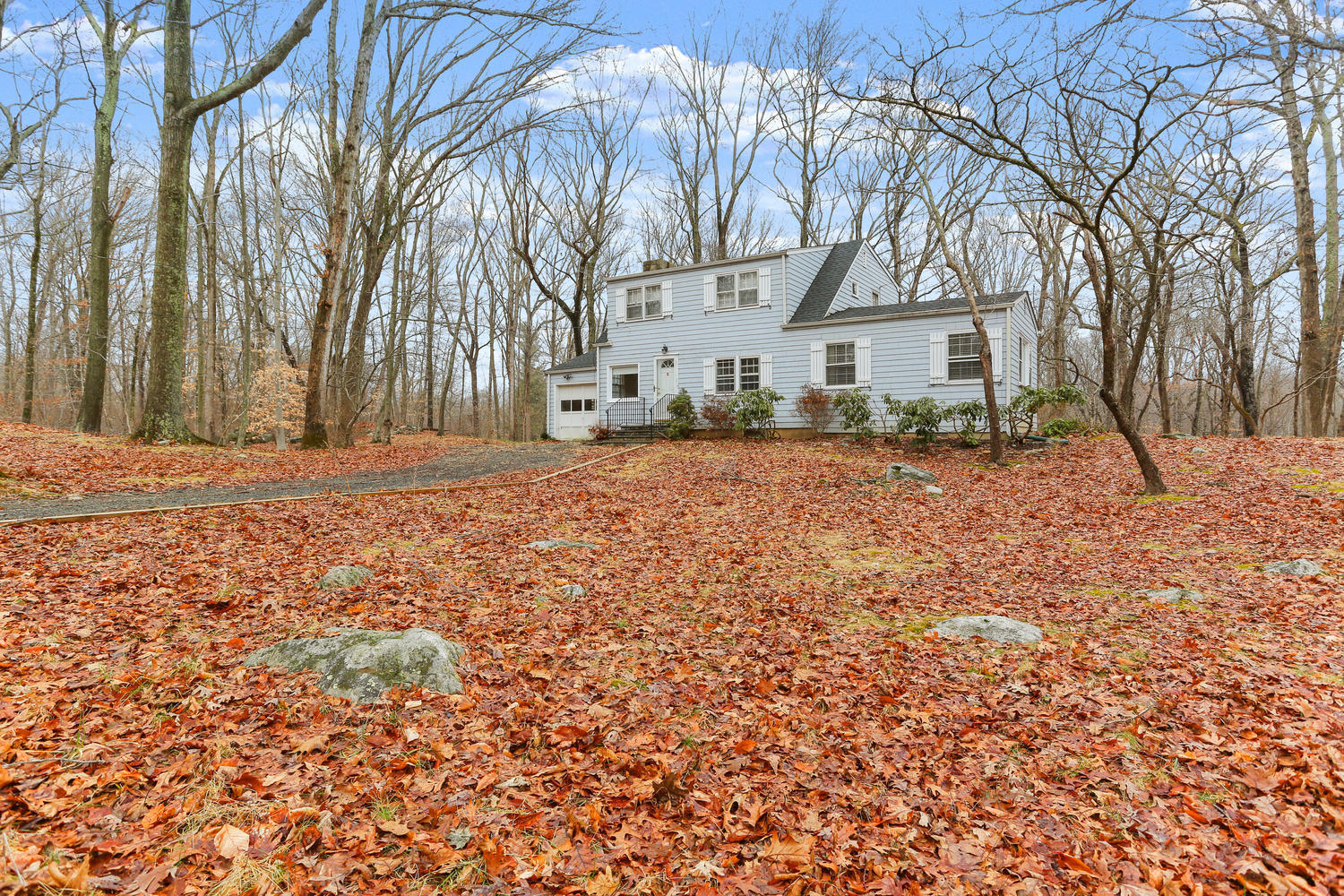 161 Spring Water Lane New Canaan, CT 06840 - Photo 3 of 9 a wooden bench sitting in middle of yard