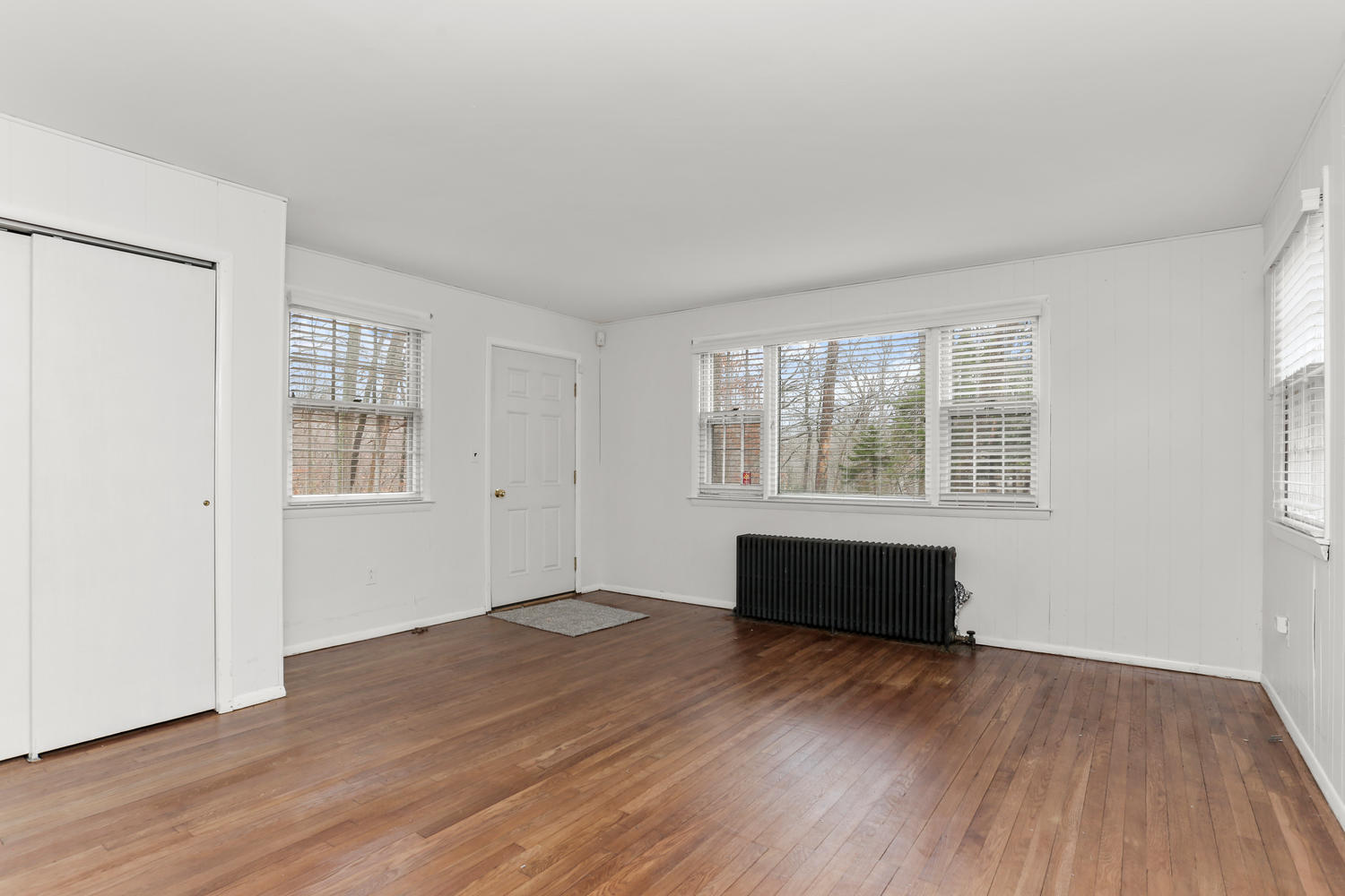 161 Spring Water Lane New Canaan, CT 06840 - Photo 5 of 9 an empty room with wooden floor and windows