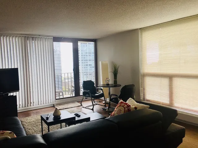 a living room with furniture and large windows