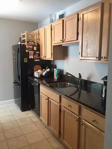 a kitchen with stainless steel appliances granite countertop a refrigerator sink and cabinets