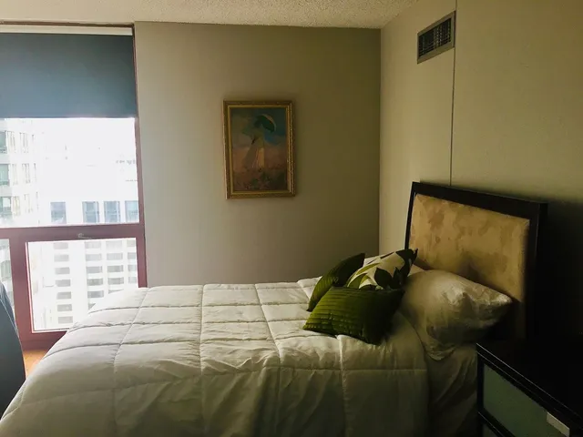 a bedroom with a bed and window