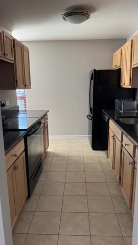 a kitchen with a refrigerator and a sink