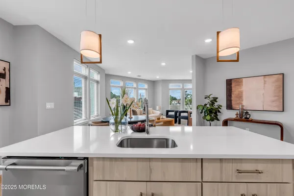 a kitchen with sink and a mirror