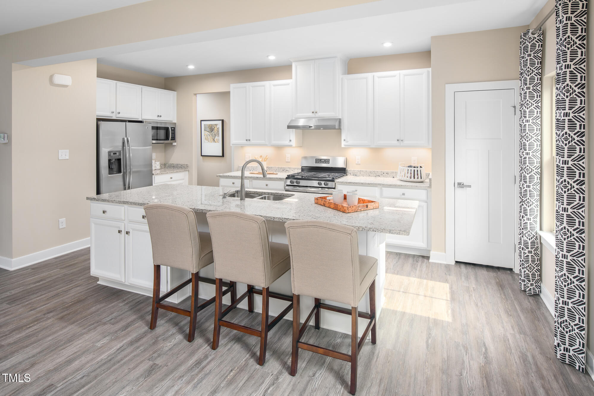 812 Walker Rdg Way Willow Spring, NC 27592 - Photo 3 of 23 a kitchen with stainless steel appliances a dining table chairs refrigerator and sink