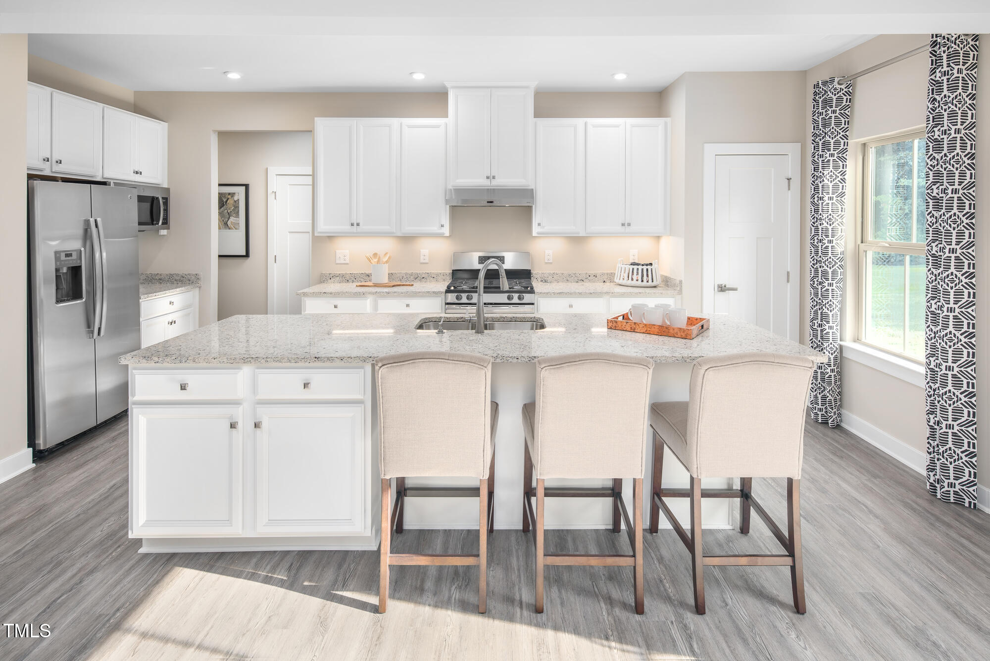 812 Walker Rdg Way Willow Spring, NC 27592 - Photo 6 of 23 a kitchen with stainless steel appliances kitchen island granite countertop a dining table chairs and white cabinets