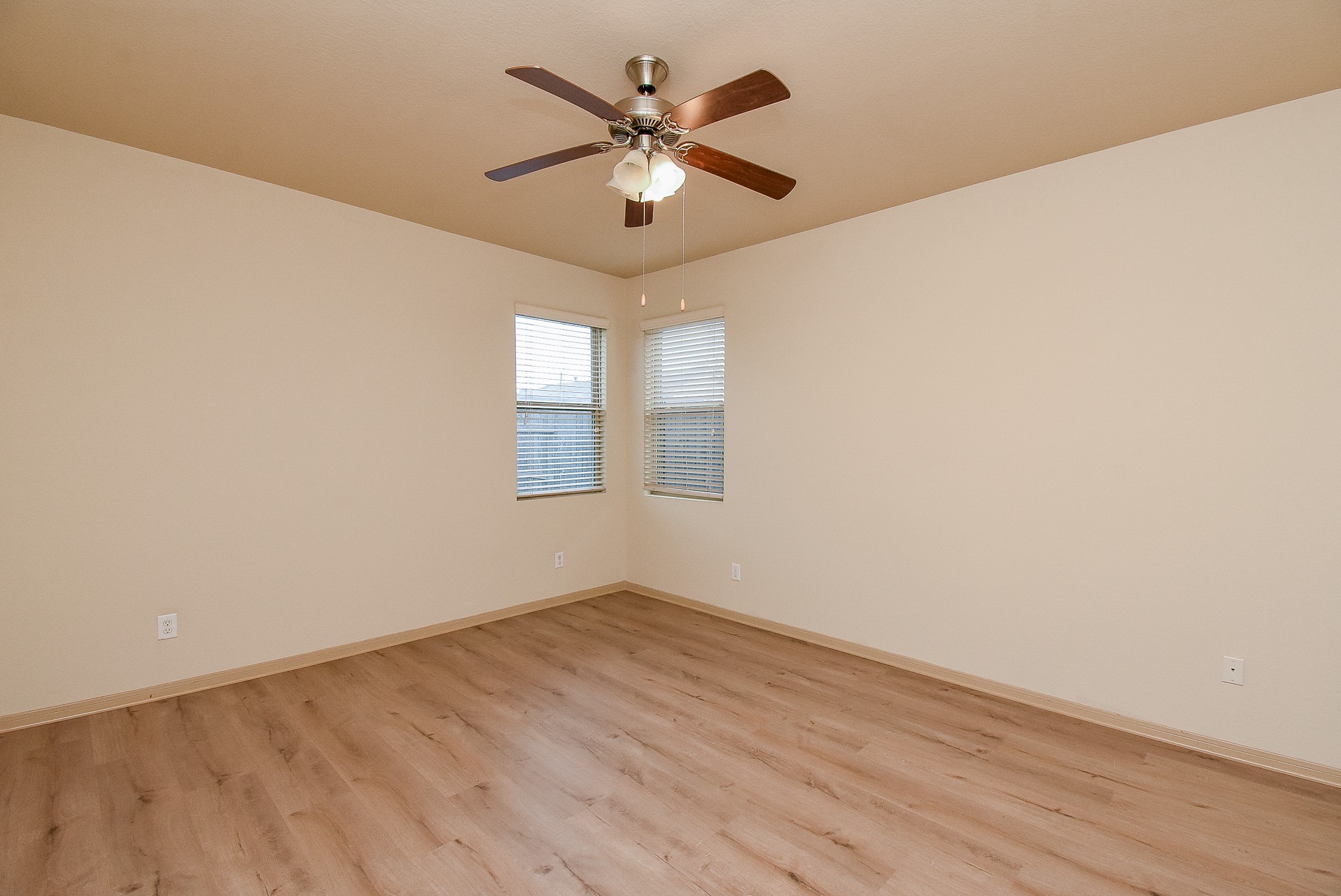 2106 Harmon Crest Court Spring, TX 77373 - Photo 14 of 32 an empty room with wooden floor and ceiling fan