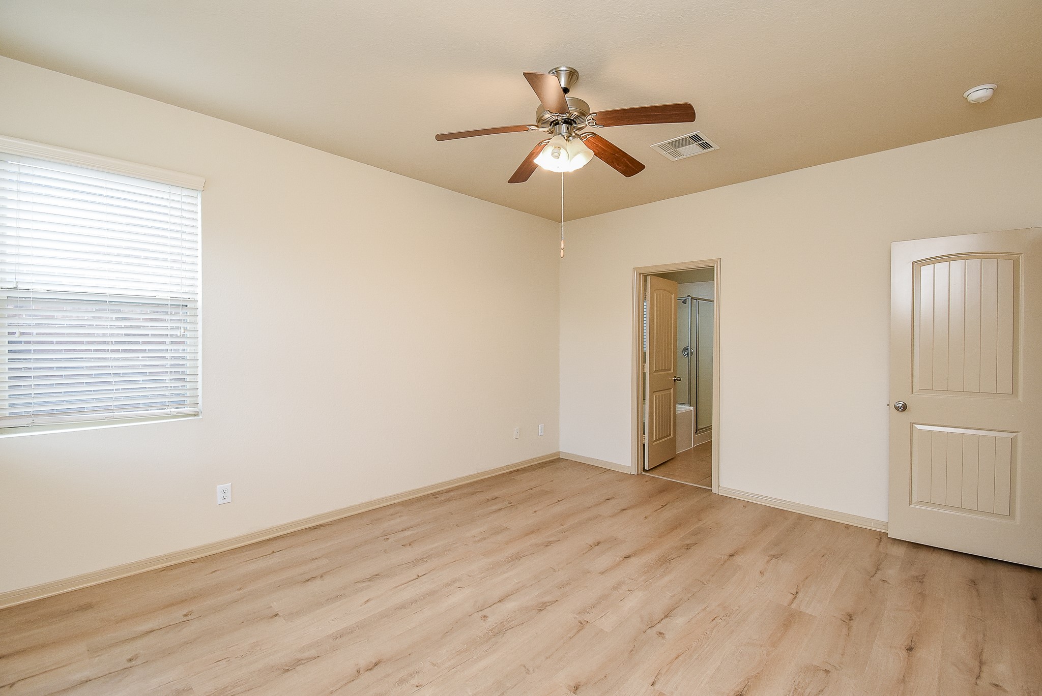 2106 Harmon Crest Court Spring, TX 77373 - Photo 15 of 32 a view of an empty room with wooden floor and a window