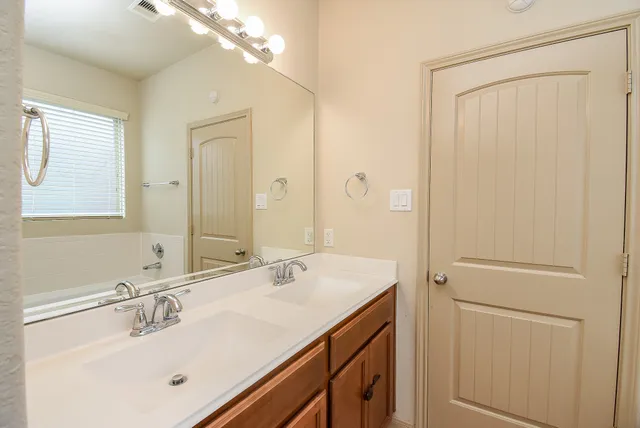 a bathroom with a sink vanity and mirror