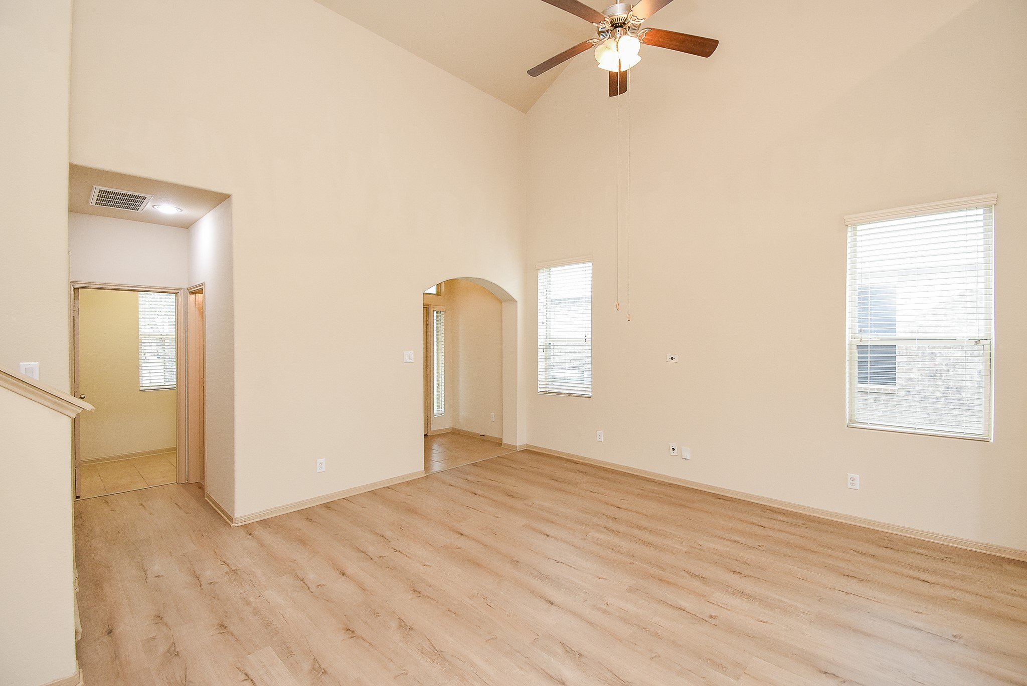 2106 Harmon Crest Court Spring, TX 77373 - Photo 7 of 32 an empty room with wooden floor fan and windows