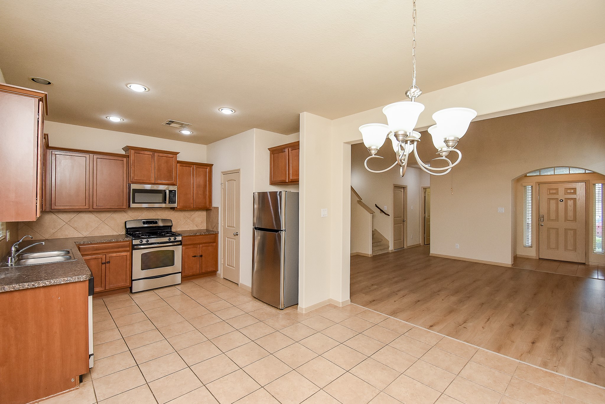 2106 Harmon Crest Court Spring, TX 77373 - Photo 9 of 32 a kitchen with stainless steel appliances granite countertop a refrigerator and a stove top oven
