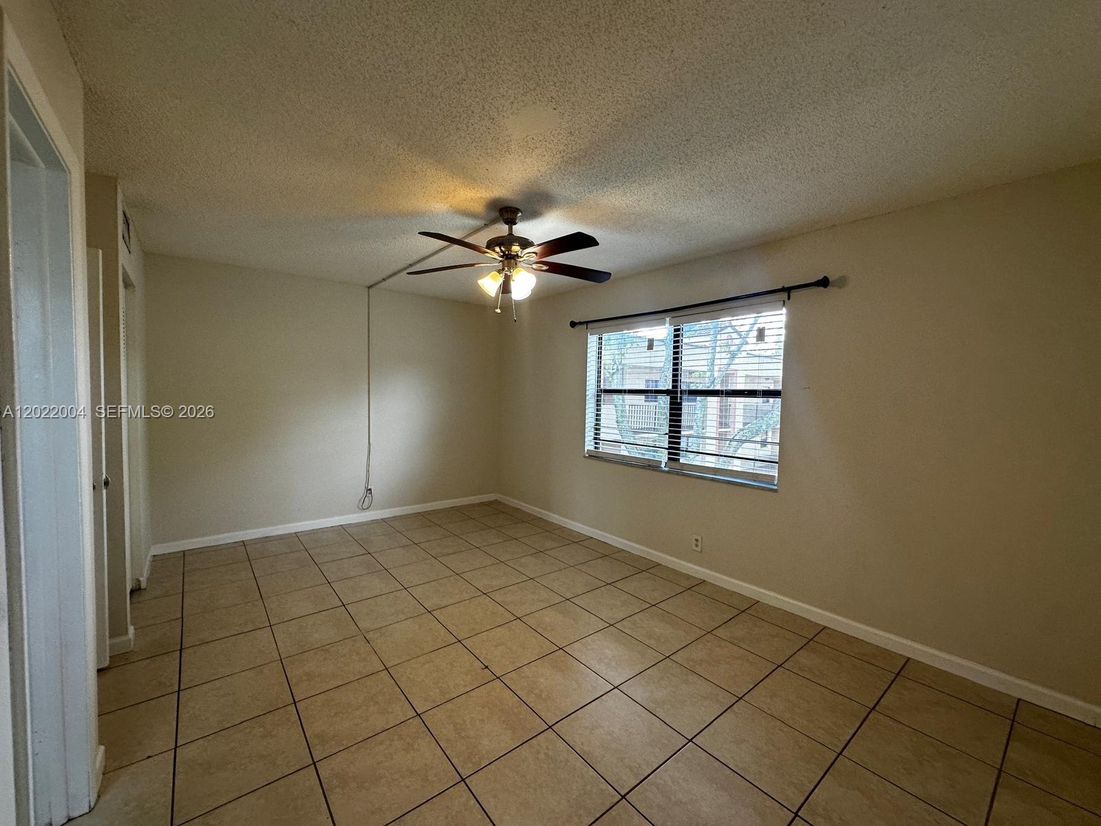 3400 Foxcroft Road, Unit 301 Miramar, FL 33025 - Photo 49 of 72 an empty room with windows and fan