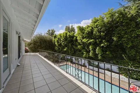 a view of balcony with lots of trees