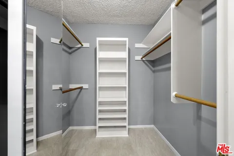 a view of closet area with empty racks