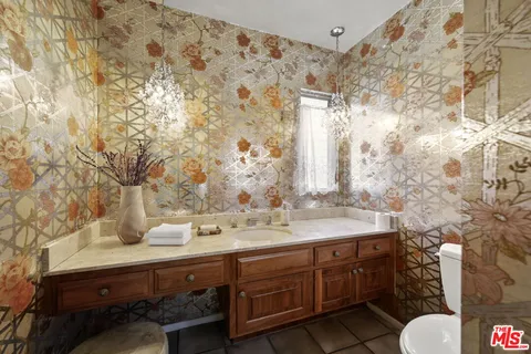 a bathroom with a sink mirror and vanity