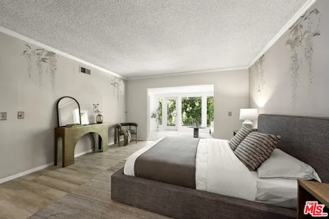 a bedroom with bed a table and a window