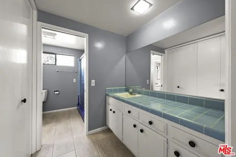 a bathroom with a granite countertop sink mirror and double