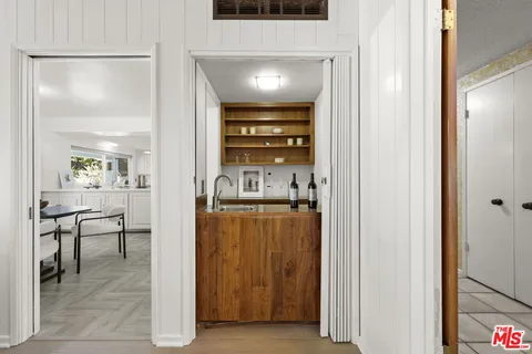 a view of a hallway with dining room and chair