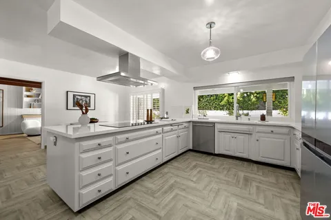 a large kitchen with stainless steel appliances granite countertop a stove and a sink